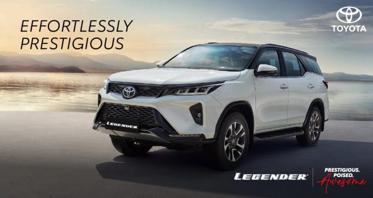 a white car parked on a beach-toyota fortuner